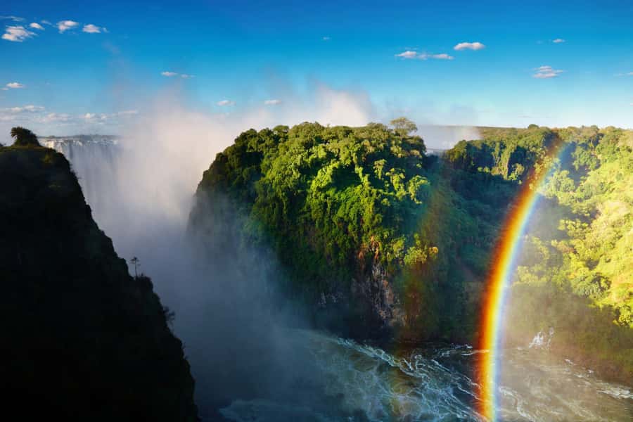 The main curtain of Victoria Falls in flood, rainbow over the gorge