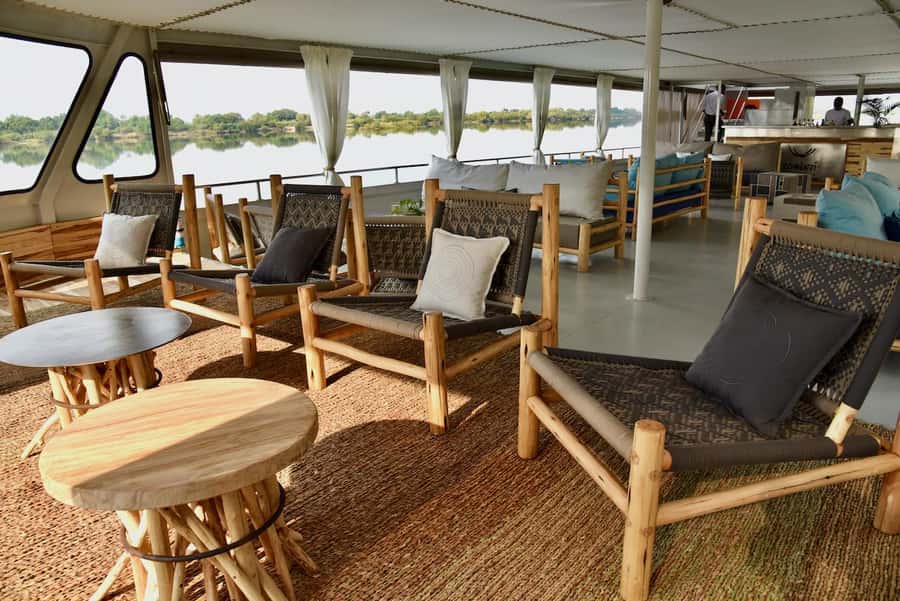 Victoria Falls: Zambezi River Relaxing Sunset Boat Cruise - Sunset, spray, and views toward Victoria Falls